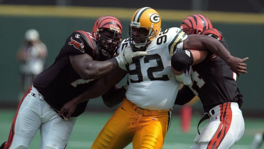 Sep 20, 1998; Cincinnati, OH, USA; Green Bay Packers defensive tackle Reggie White (92) fights off a double team from Cincinnati Bengals tackle Willie Anderson (71) and fullback Brian Milne (44) at Riverfront Stadium. The Packers beat the Bengals 13-6