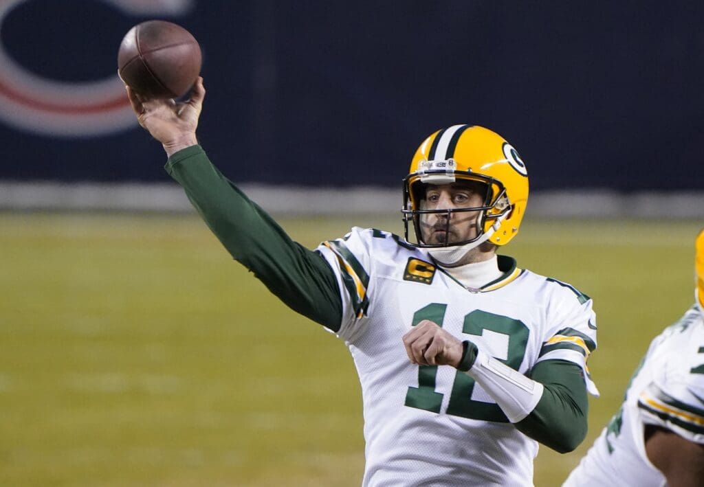 Jan 3, 2021; Chicago, Illinois, USA; Green Bay Packers quarterback Aaron Rodgers (12) throws a touchdown pass against the Chicago Bears during the second quarter at Soldier Field.