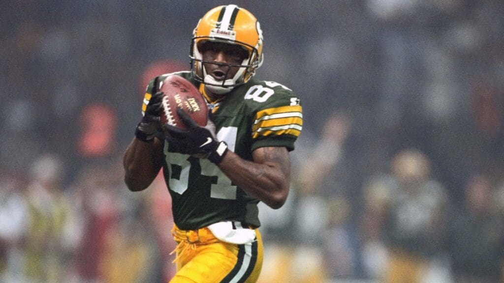 Jan 26, 1997; New Orleans, LA, USA; FILE PHOTO; Green Bay Packers receiver #84 Andre Rison catches a 54 yard touchdown pass against the New England Patriots during Super Bowl XXXI at the Superdome. The Packers defeated the Patriots 35-21.