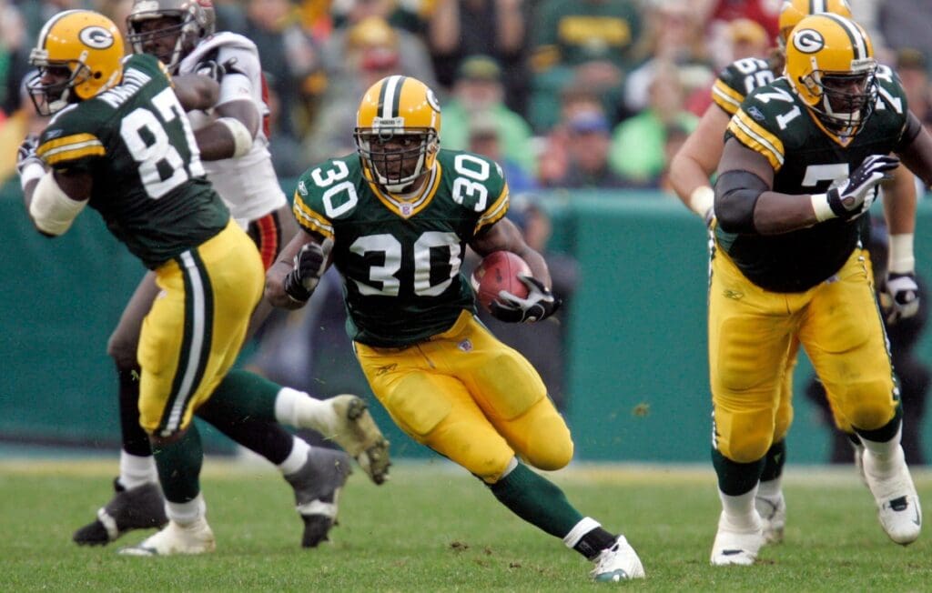 Green Bay Packers running back Ahman Green runs though a hole in the Tampa Bay Buccanneer’s defense for an 11-yard gain during the third quarter of their game on Sept. 25, 2005 at Lambeau Field in Green Bay, Wis. Tampa Bay won 17-16.
