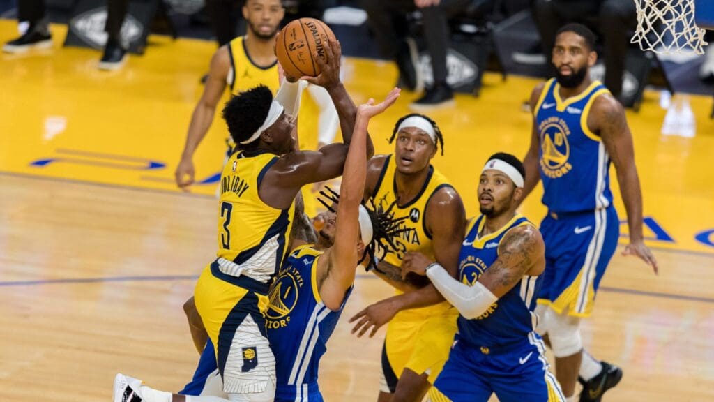 Jan 12, 2021; San Francisco, California, USA; Indiana Pacers guard Aaron Holiday (3) shoots as Golden State Warriors guard Damion Lee (1) defends in the first half at Chase Center.