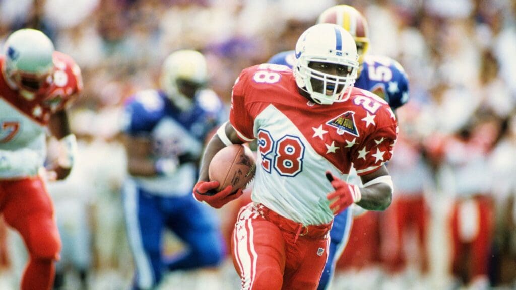Feb 5, 1995; Honolulu, HI, USA; FILE PHOTO; Indianapolis Colts running back Marshall Faulk (28) carries the ball during the 1995 Pro Bowl at Aloha Stadium. During this game Faulk rushed for a record setting 180 yards. 