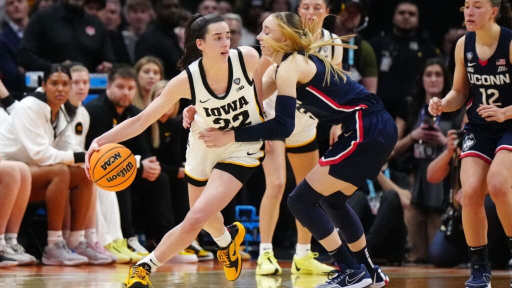 Apr 5, 2024; Cleveland, OH, USA; Iowa Hawkeyes guard Caitlin Clark (22) controls the ball against Connecticut Huskies guard Paige Bueckers (5) in the fourth quarter in the semifinals of the Final Four of the womens 2024 NCAA Tournament at Rocket Mortgage FieldHouse