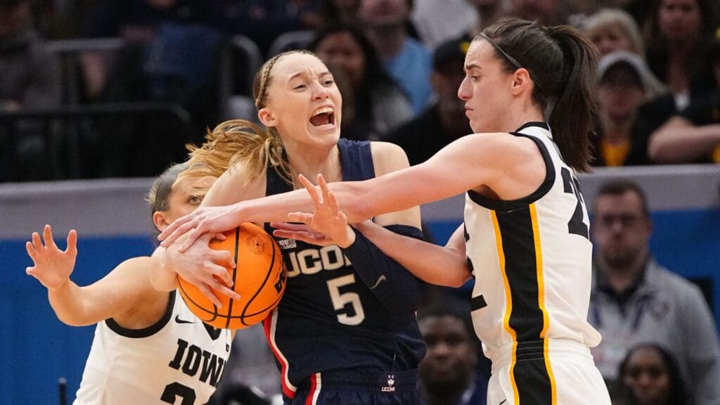 Iowa Hawkeyes guard Caitlin Clark (22) is called for a foul on UConn Huskies guard Paige Bueckers (5) during the Final Four round of the NCAA Women's Basketball Tournament between Iowa and UConn at Rocket Mortgage Fieldhouse, Friday, April 5, 2024 in Cleveland.