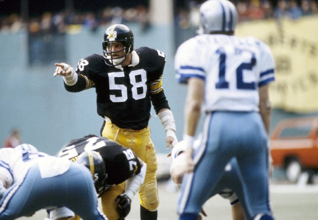 Oct 28, 1979; Pittsburgh, PA, USA: FILE PHOTO; Pittsburgh Steelers linebacker Jack Lambert (58) signals in front of Dallas Cowboys quarterback Roger Staubach (12) at three Rivers Stadium.