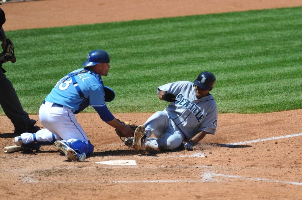 April 28, 2010; Kansas City, MO, USA; Kansas City Royals catcher Jason Kendall (18) makes the tag on Seattle Mariners second baseman Chone Figgins (9) at home in the fifth inning at Kauffman Stadium.