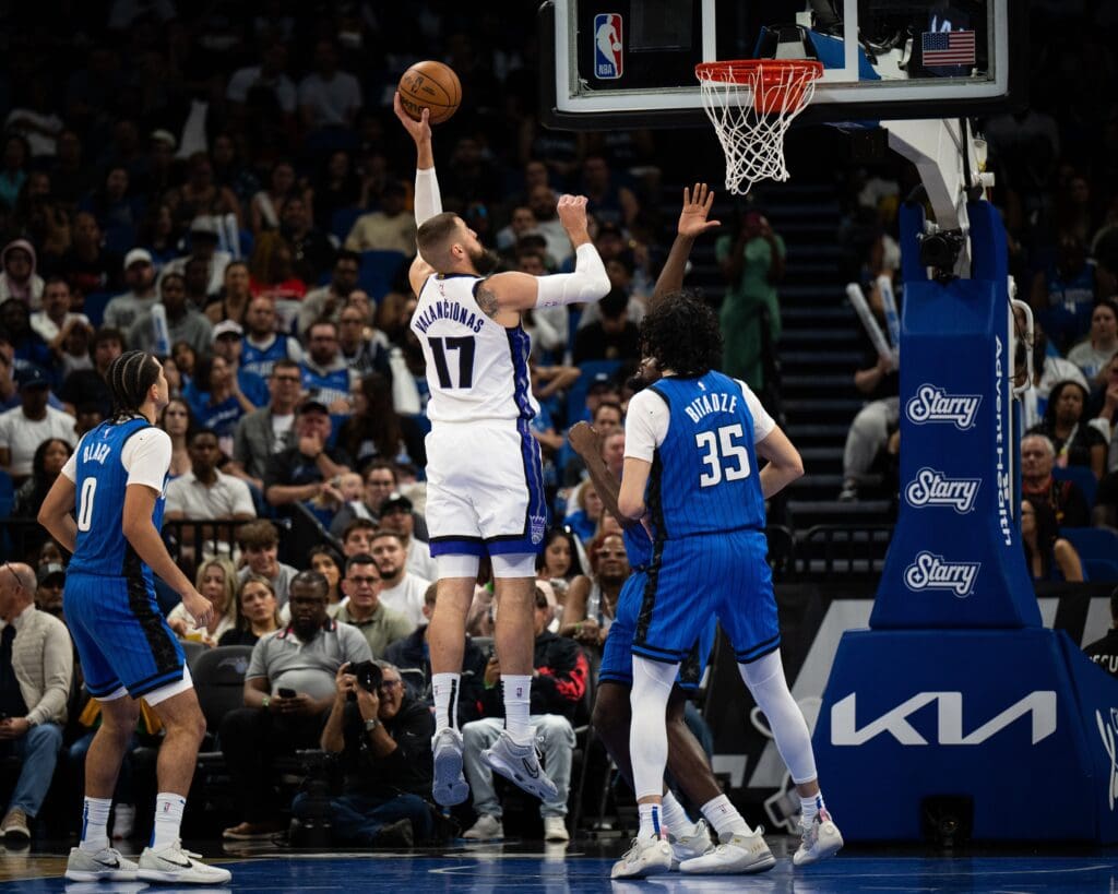 Mar 29, 2025; Orlando, Florida, USA; Sacramento Kings center Jonas Valančiūnas (17) shoots the ball over Orlando Magic center Goga Bitadze (35) in the fourth quarter at Kia Center. Mandatory Credit: Jeremy Reper-Imagn Images