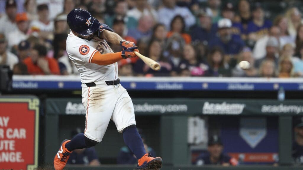 May 24, 2025; Houston, Texas, USA; Houston Astros second baseman Jose Altuve (27) hits a single during the third inning against the Seattle Mariners at Daikin Park.