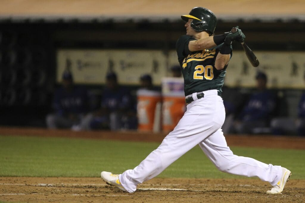Sep 3, 2013; Oakland, CA, USA; Oakland Athletics third baseman Josh Donaldson (20) hits a double against the Texas Rangers during the third inning at O.co Coliseum.