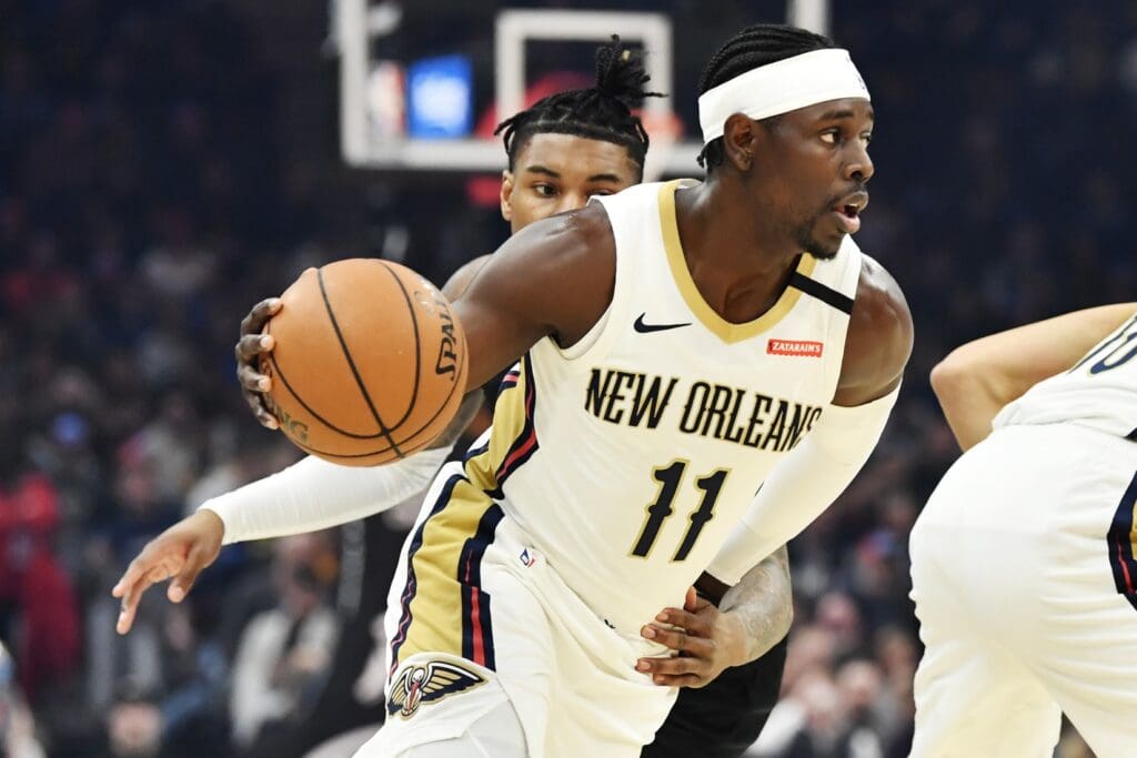 Jan 28, 2020; Cleveland, Ohio, USA; New Orleans Pelicans guard Jrue Holiday (11) drives to the basket against Cleveland Cavaliers guard Kevin Porter Jr. (4) during the first half at Rocket Mortgage FieldHouse.