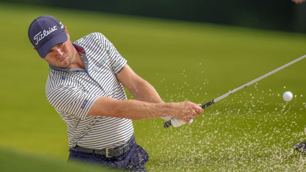 May 14, 2025; Charlotte, North Carolina, USA; Justin Thomas hits out of the bunker on the 16th hole during a practice round for the PGA Championship golf tournament at Quail Hollow.