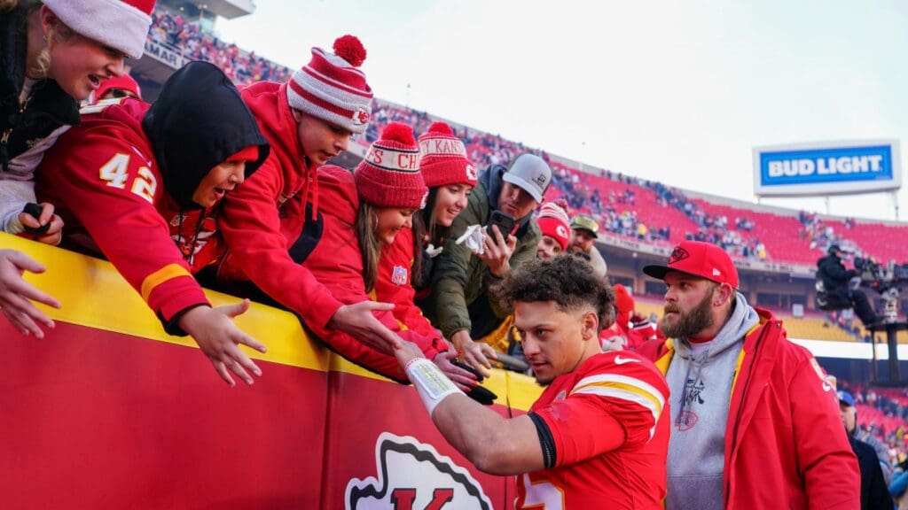 Kansas City Chiefs quarterback Patrick Mahomes (15) greets fans while leaving the stadium after the win over the Houston Texans at GEHA Field at Arrowhead Stadium.