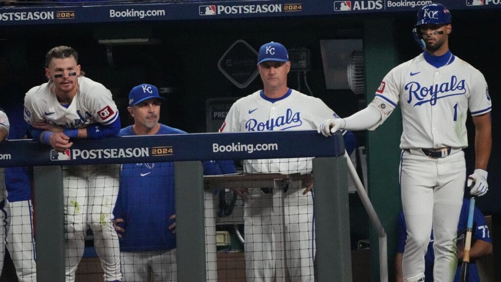 Oct 10, 2024; Kansas City, Missouri, USA; Kansas City Royals manager Matt Quatraro (33), outfielder MJ Melendez (1) and shortstop Bobby Witt Jr. (7) watch play from the dugout during the ninth inning against the New York Yankees during game four of the ALDS for the 2024 MLB Playoffs at Kauffman Stadium