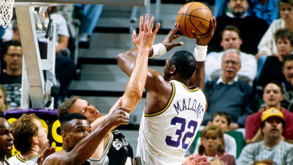Apr 14, 1994; Salt Lake City, UT, USA; FILE PHOTO; Utah Jazz forward Karl Malone (32) is defended by San Antonio Spurs center David Robinson (50)and Will Perdue (41) at the Delta Center.