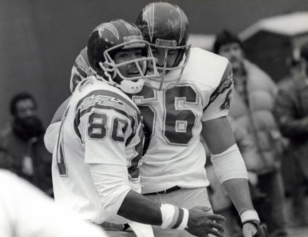Jan 9, 1983; Pittsburgh, PA, USA; FILE PHOTO; San Diego Chargers tight end Kellen Winslow (80) celebrates an 8 yard touchdown reception with tackle Billy Shields (66) in the fourth quarter against the Pittsburgh Steelers at Three Rivers Stadium. The Chargers beat the Steelers 31-28.
