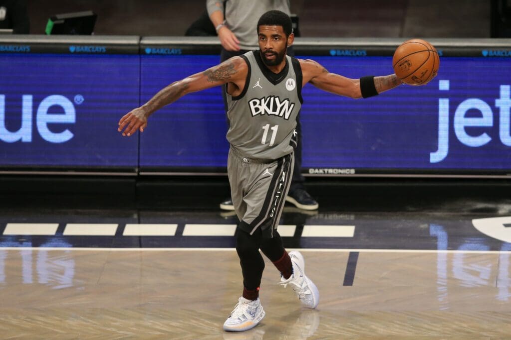 Jan 3, 2021; Brooklyn, New York, USA; Brooklyn Nets point guard Kyrie Irving (11) passes the ball against the Washington Wizards during the second quarter at Barclays Center.
