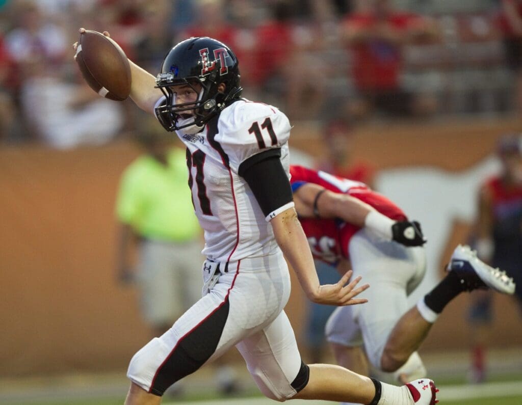 Lake Travis quarterback Baker Mayfield runs for a touchdown in the first quarter against Westlake at Royal-Memorial Stadium on Saturday, August 27, 2011.