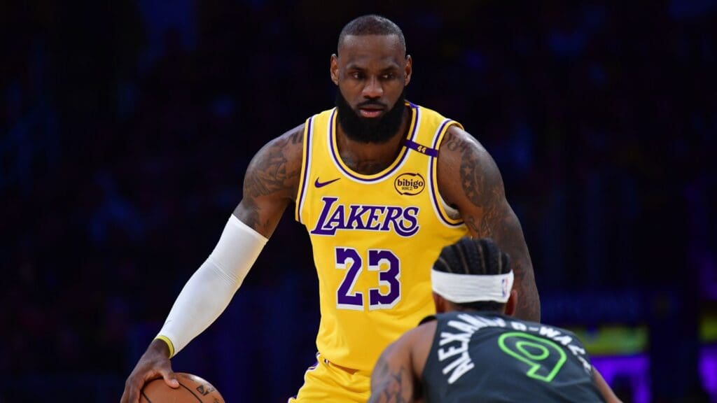 Apr 30, 2025; Los Angeles, California, USA; Los Angeles Lakers forward LeBron James (23) controls the ball against Minnesota Timberwolves guard Nickeil Alexander-Walker (9) during the first half in game five of first round for the 2025 NBA Playoffs at Crypto.com Arena.