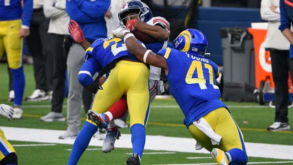 Oct 4, 2020; Inglewood, California, USA; Los Angeles Rams cornerback Jalen Ramsey (20) makes a leaping tackle to stop New York Giants wide receiver Golden Tate (15) during the second half at SoFi Stadium. Rifghrt is Los Angeles Rams outside linebacker Kenny Young (41)