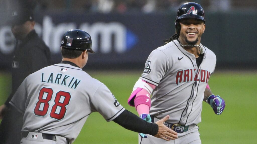 May 23, 2025; St. Louis, Missouri, USA; Arizona Diamondbacks second baseman Ketel Marte (4) is congratulated by third base coach Shaun Larkin (88) after hitting a solo home run against the St. Louis Cardinals during the fourth inning at Busch Stadium.