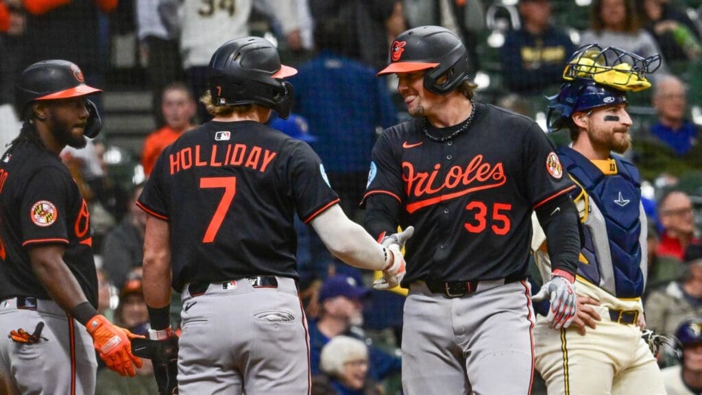 May 21, 2025; Milwaukee, Wisconsin, USA; Baltimore Orioles catcher Adley Rutschman (35) is greeted by second baseman Jackson Holliday (7) after hitting a 3-run home run in the eleventh inning as Milwaukee Brewers catcher Eric Haase (13) looks on at American Family Field