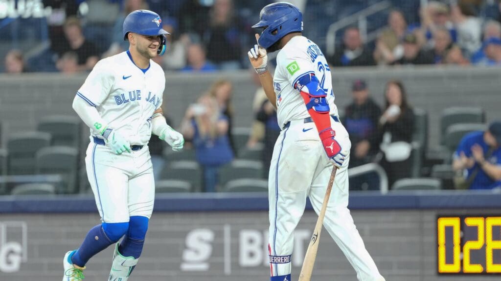 May 3, 2025; Toronto, Ontario, CAN; Toronto Blue Jays shortstop Bo Bichette (11) hits a home run and celebrates with baseman Vladimir Guerrero Jr. (27) against the Cleveland Guardians during the first inning at Rogers Centre.