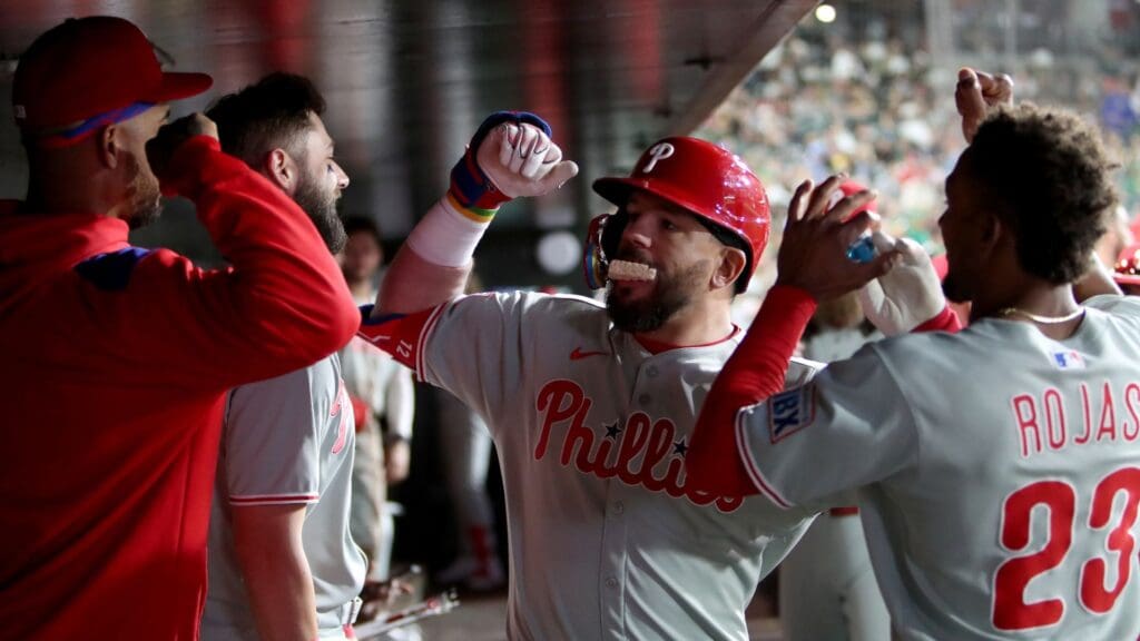 May 24, 2025; West Sacramento, California, USA; Philadelphia Phillies designated hitter Kyle Schwarber (12) is congratulated by teammates in the dugout after hitting a solo home run against the Athletics during the sixth inning at Sutter Health Park.
