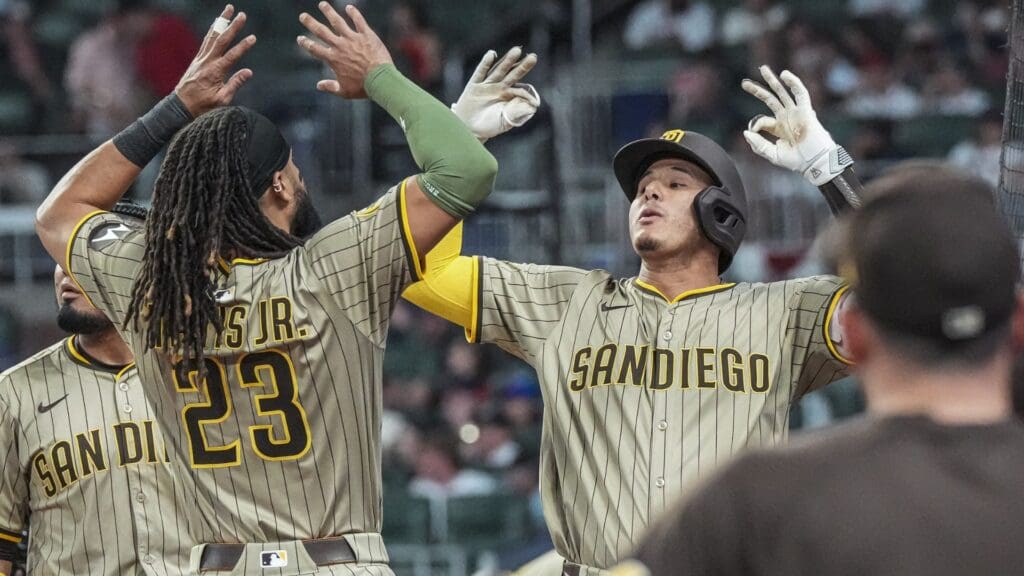 May 23, 2025; Cumberland, Georgia, USA; San Diego Padres third baseman Manny Machado (13) reacts with right fielder Fernando Tatis Jr. (23) after hitting a go ahead home run against the Atlanta Braves during the ninth inning at Truist Park.