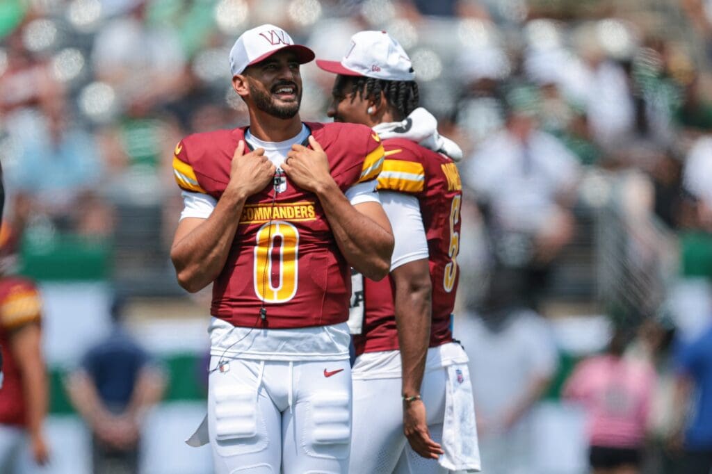 Aug 10, 2024; East Rutherford, New Jersey, USA; Washington Commanders quarterback Marcus Mariota (0) looks on during the first half against the New York Jets at MetLife Stadium. Mandatory Credit: Vincent Carchietta-USA TODAY Sports