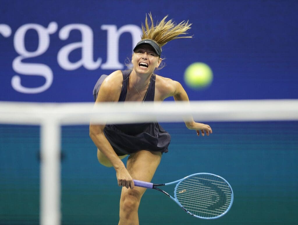Aug 26, 2019; Flushing, NY, USA; Maria Sharapova of Russia serves against Serena Williams of the United States in a first round match on day one of the 2019 U.S. Open tennis tournament at USTA Billie Jean King National Tennis Center.