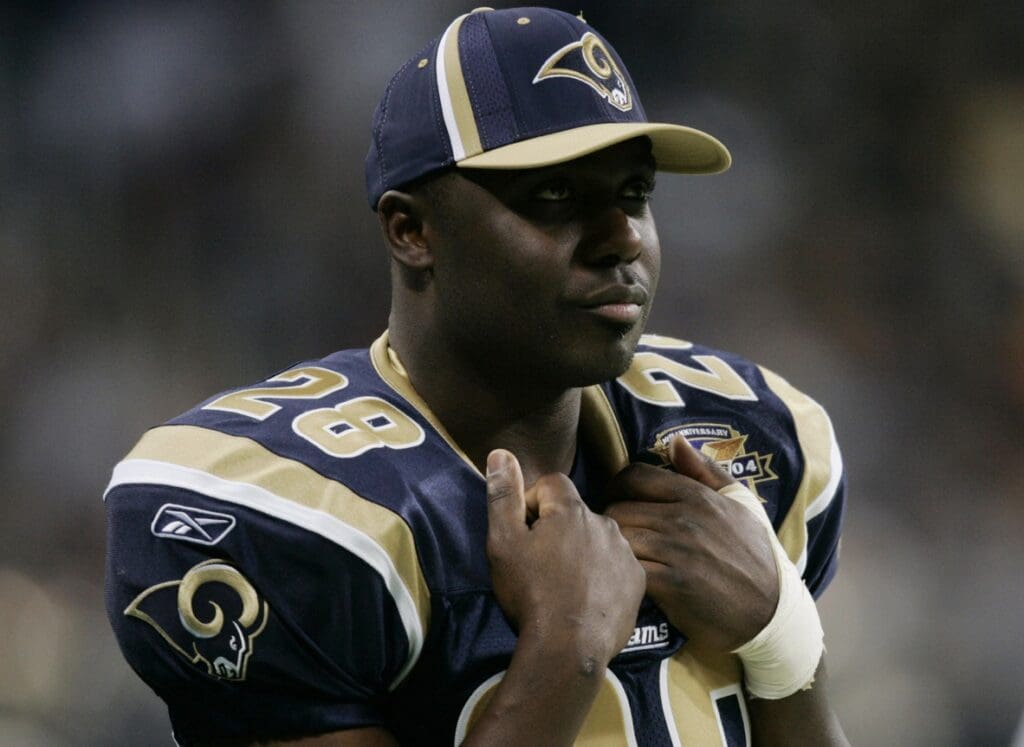 Dec 5, 2004; St. Louis, MO, USA; Running back Marshall Faulk #28 of the St. Louis Rams watches his team play the San Francisco 49ers at the Edward Jones Dome. Faulk did not play due to an knee injury. The Rams beat the 49ers 16-6.