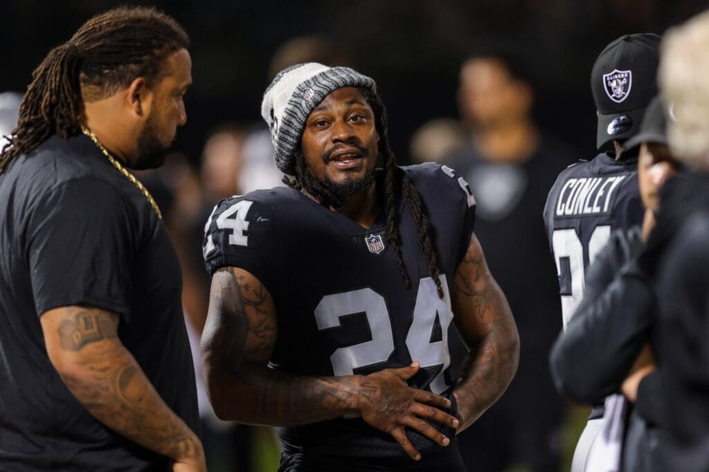Aug 10, 2018; Oakland, CA, USA; Oakland Raiders running back Marshawn Lynch (24) speaks with offensive tackle Donald Penn (72) during the second quarter against the Detroit Lions at Oakland Coliseum. Mandatory Credit: Sergio Estrada-USA TODAY Sports