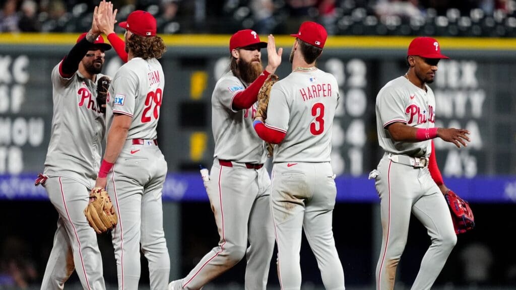 May 21, 2025; Denver, Colorado, USA; Members of the Philadelphia Phillies celebrate defeating the Colorado Rockies at Coors Field.