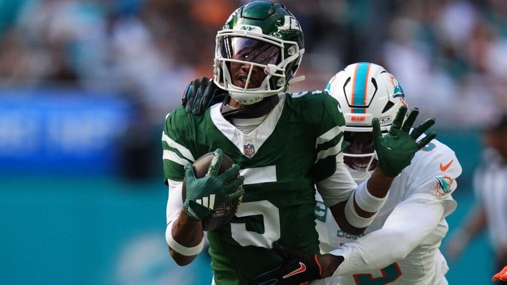 Dec 8, 2024; Miami Gardens, Florida, USA; Miami Dolphins cornerback Jalen Ramsey (5) attempts to tackle New York Jets wide receiver Garrett Wilson (5) during the first half at Hard Rock Stadium.