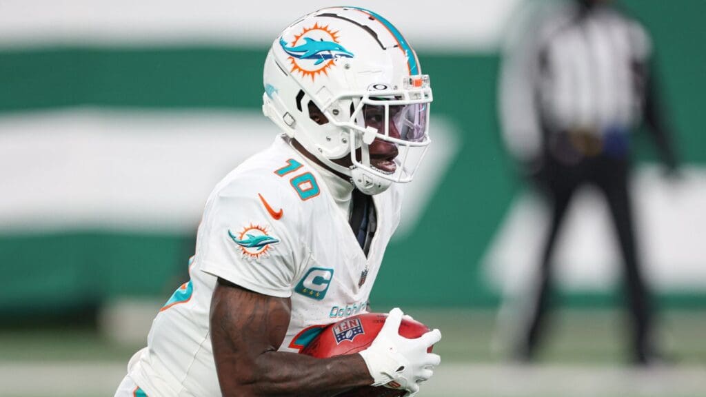 Jan 5, 2025; East Rutherford, New Jersey, USA; Miami Dolphins wide receiver Tyreek Hill (10) returns punt during the first half against the New York Jets at MetLife Stadium.
