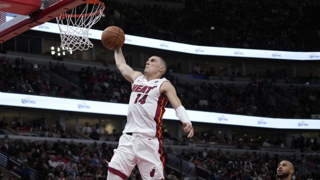 Apr 16, 2025; Chicago, Illinois, USA; Miami Heat guard Tyler Herro (14) goes up for a dunk on Chicago Bulls forward Talen Horton-Tucker (22) during the second half at United Center.