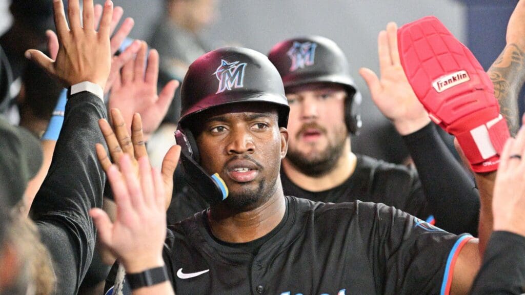 Sep 28, 2024; Toronto, Ontario, CAN; Miami Marlinsright fielder Jesus Sanchez 12) celebrates in the dugout with team mates after scoring against the Toronto Blue Jays in the sixth inning at Rogers Centre