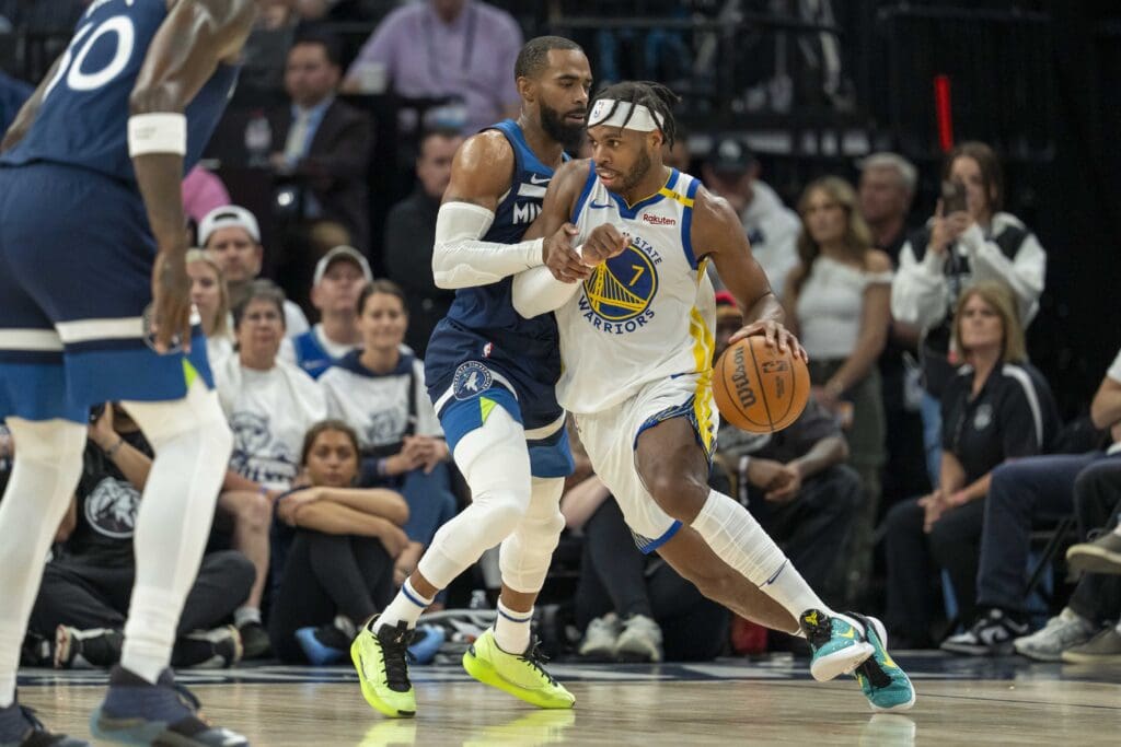 May 14, 2025; Minneapolis, Minnesota, USA; Golden State Warriors guard Buddy Hield (7) dribbles the ball as Minnesota Timberwolves guard Mike Conley (10) plays defense in the first half during game five of the second round for the 2025 NBA Playoffs at Target Center. Mandatory Credit: Jesse Johnson-Imagn Images