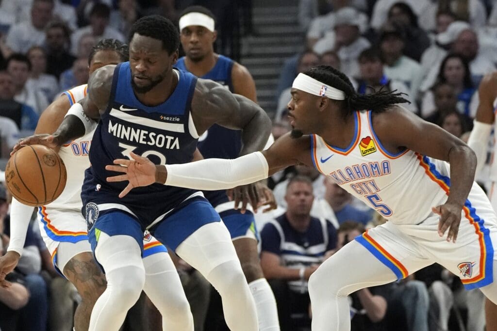May 26, 2025; Minneapolis, Minnesota, USA; Minnesota Timberwolves forward Julius Randle (30) dribbles the ball against Oklahoma City Thunder guard Luguentz Dort (5) in the first half in game four of the western conference finals for the 2025 NBA Playoffs at Target Center.