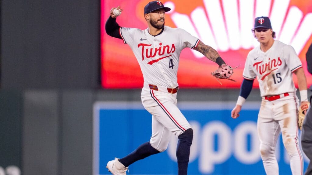 Apr 23, 2025; Minneapolis, Minnesota, USA; Minnesota Twins shortstop Carlos Correa (4) turns a double play off a ball hit by Chicago White Sox first base Bobby Dalbec (31) in the sixth inning at Target Field.