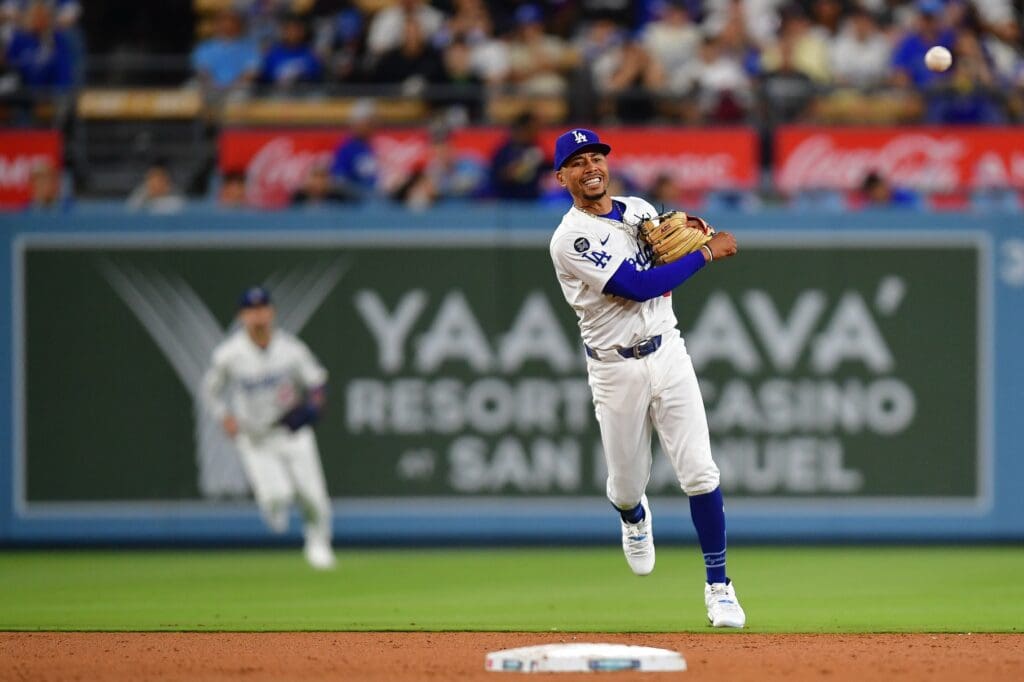 May 19, 2025; Los Angeles, California, USA; Los Angeles Dodgers shortstop Mookie Betts (50) throws to first for the out against Arizona Diamondbacks catcher Gabriel Moreno (14) during the seventh inning at Dodger Stadium.