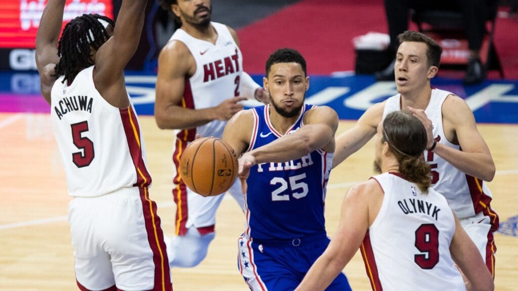 Jan 12, 2021; Philadelphia, Pennsylvania, USA; Philadelphia 76ers guard Ben Simmons (25) passes the ball against Miami Heat forward Precious Achiuwa (5) and forward Kelly Olynyk (9) during the third quarter at Wells Fargo Center