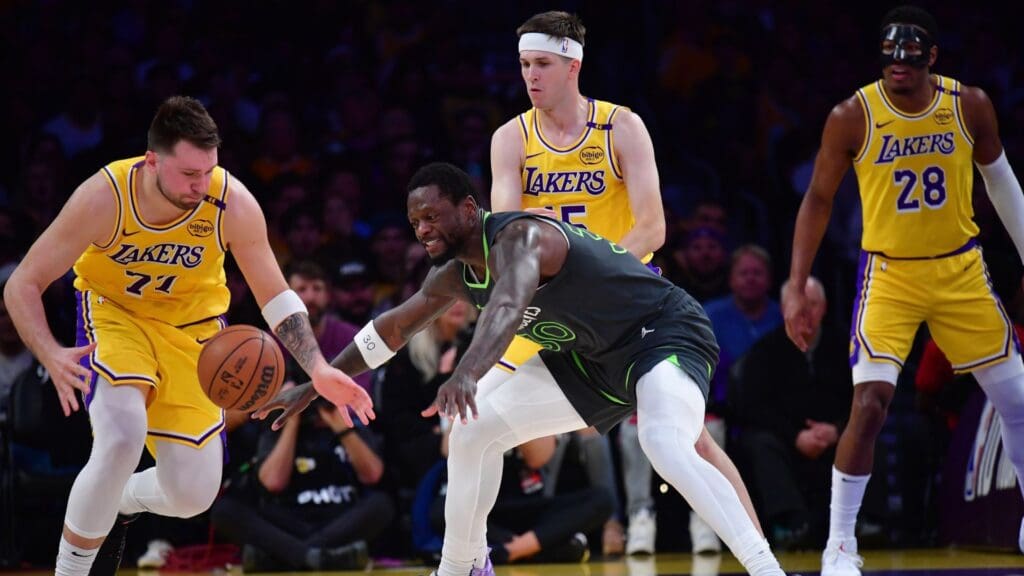 Apr 30, 2025; Los Angeles, California, USA; Los Angeles Lakers guard Luka Doncic (77) plays for the ball against Minnesota Timberwolves forward Julius Randle (30) during the first half in game five of first round for the 2025 NBA Playoffs at Crypto.com Arena