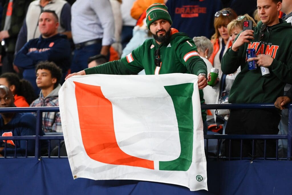Nov 30, 2024; Syracuse, New York, USA; A Miami Hurricanes fan holds a flag during the first half against the Syracuse Orange at the JMA Wireless Dome