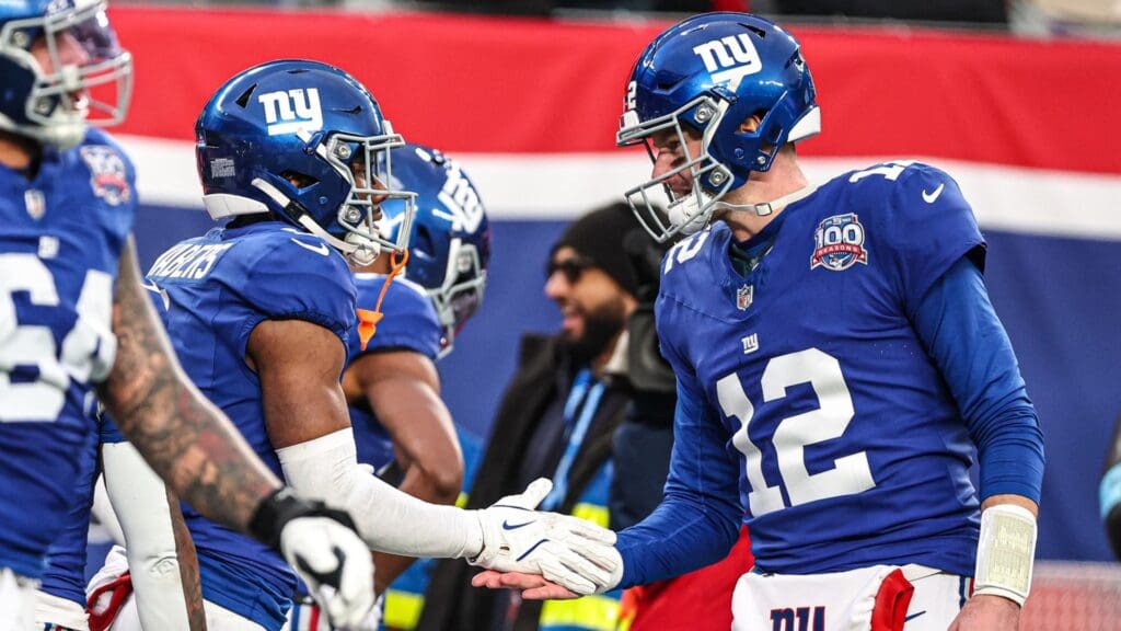 Dec 15, 2024; East Rutherford, New Jersey, USA; New York Giants wide receiver Malik Nabers (1) celebrates his touchdown reception from quarterback Tim Boyle (12) during the second half against the Baltimore Ravens at MetLife Stadium.