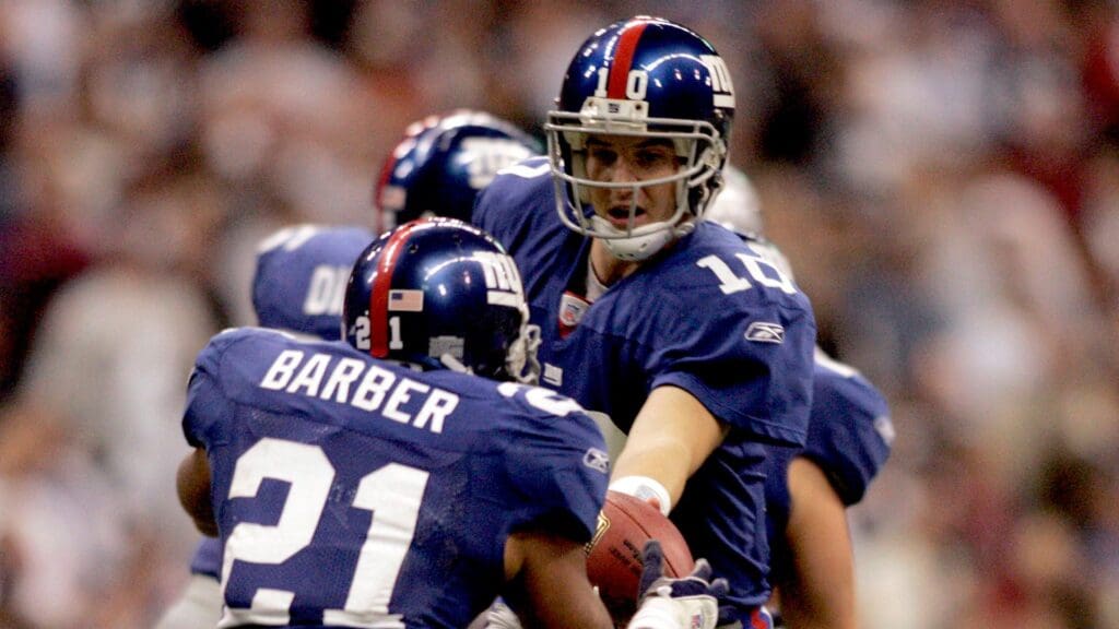 Oct 23, 2006; Irving, TX USA; New York Giants quarterback (10) Eli Manning hands of to running back (21) Tiki Barber during the second quarter against the Dallas Cowboys at Texas Stadium.