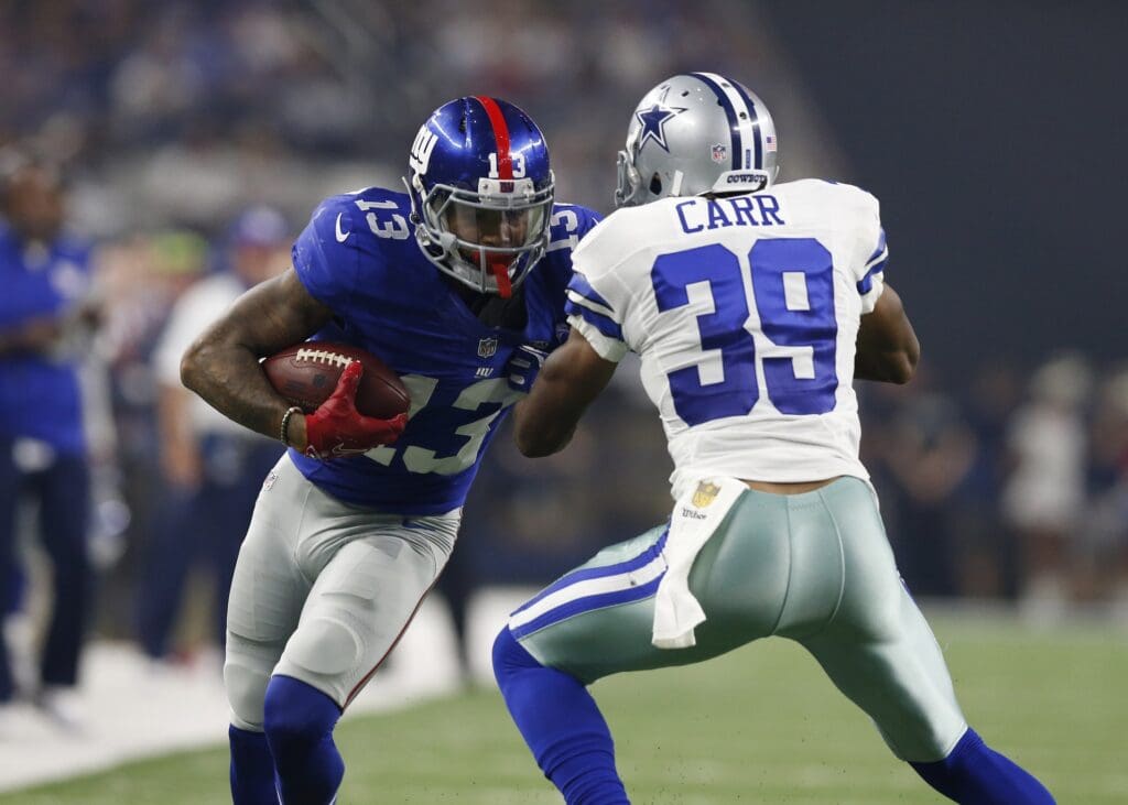 Sep 13, 2015; Arlington, TX, USA; New York Giants receiver Odell Beckham Jr (13) runs after a reception against Dallas Cowboys cornerback Brandon Carr (39) in the second quarter at AT&T Stadium.
