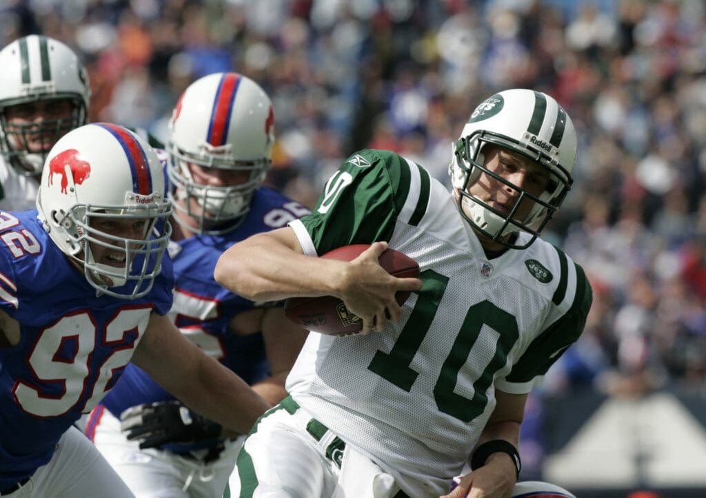 September 24, 2006; Orchard Park, NY, USA; New York Jets quarterback (10) Chad Pennington carries the ball for 7 yards as Buffalo Bills defensive end (92) Ryan Denney moves in for the tackle late in the second quarter in a game at Ralph Wilson Stadium.