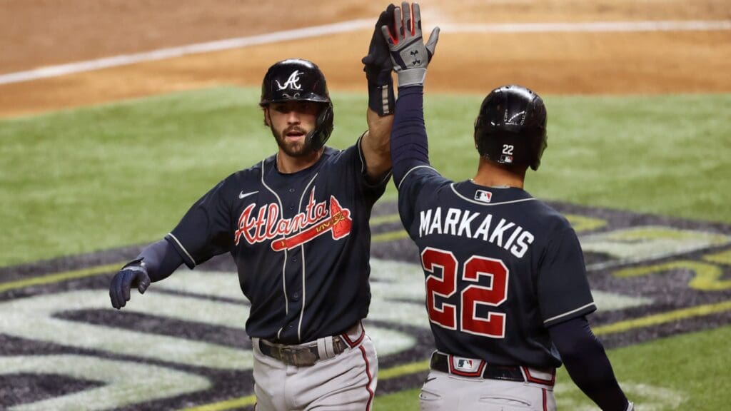 Oct 18, 2020; Arlington, Texas, USA; Atlanta Braves shortstop Dansby Swanson (7) celebrates with left fielder Nick Markakis (22) after hitting a solo home run in the second inning against the Los Angeles Dodgers during game seven of the 2020 NLCS at Globe Life Field. Mandatory Credit: Kevin Jairaj-Imagn Images