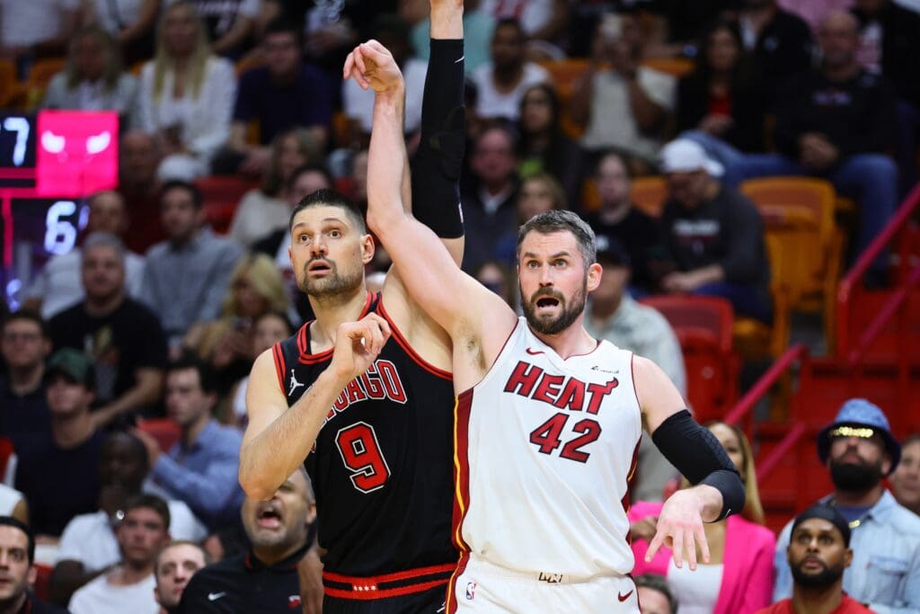 Apr 19, 2024; Miami, Florida, USA; Miami Heat forward Kevin Love (42) watches his shot against Chicago Bulls center Nikola Vucevic (9) in the fourth quarter during a play-in game of the 2024 NBA playoffs at Kaseya Center. Mandatory Credit: Sam Navarro-USA TODAY Sports